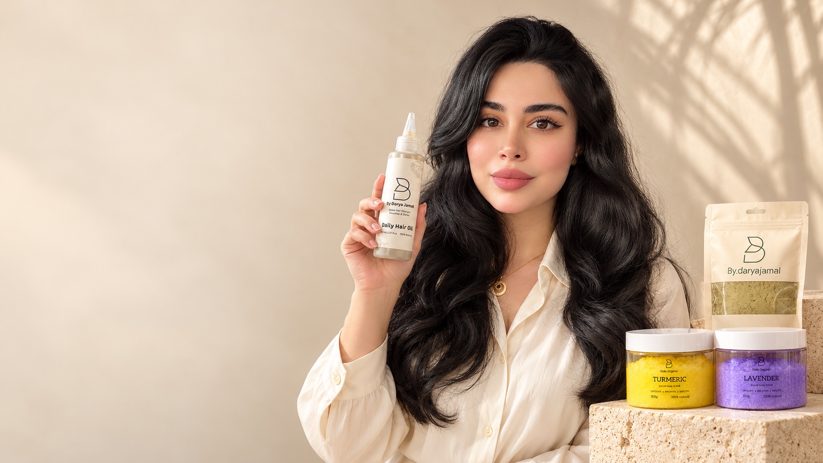 Darya J. Kamal, founder of Daily Organic, holding Daily Hair Oil